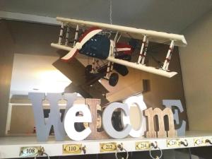 a plane on a shelf above a museum sign at Hotel MM Dateo in Milan
