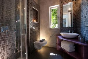 a bathroom with a sink and a toilet and a shower at Celestia Villas in Nydri +25 photos