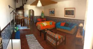 a living room with a couch and a chair at Beach House Surfing Baleal Peniche in Baleal