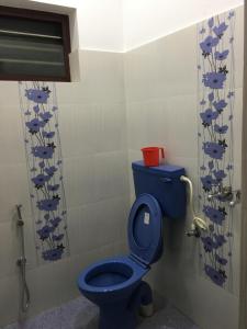 a bathroom with a blue toilet with fish on the wall at Rams Guest House Near Lulu Mall in Trivandrum +32 photos
