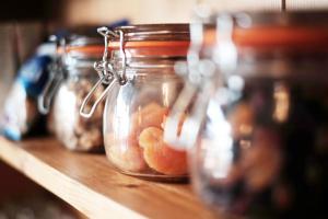 a row of glass jars filled with oranges on a shelf at Tee-Side Guest House in Bude