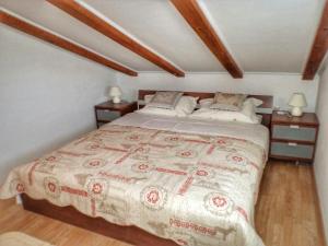 a bedroom with a large bed with two night stands at Turković Apartments in Žgaljić