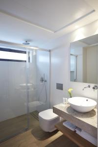 a bathroom with a toilet and a sink and a shower at Don Cesar Boutique Apartments in Benidorm