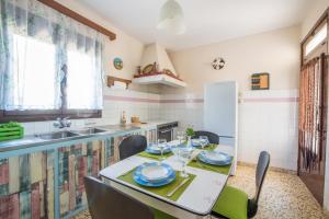 a kitchen with a table and chairs and a sink at Country House in Pastida