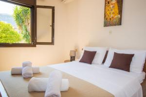 a bedroom with a large white bed with towels on it at Country House in Pastida