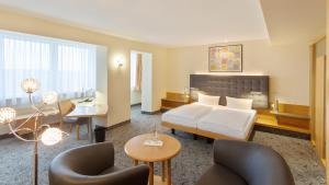 Postel nebo postele na pokoji v ubytování ABACUS Tierpark Hotel + 37 fotografií