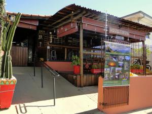 a building with a sign in front of it at Hostel Cuesta in Botucatu