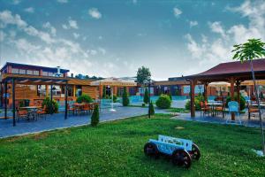 a toy tractor in the grass in front of a building at Holiday Resort in Velika Slatina