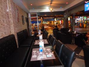 a dining room with a table with a bottle on it at Chill Inn in Pattaya