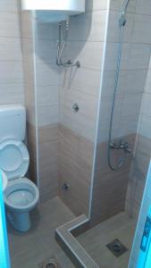 a bathroom with a shower and a toilet at Aparmani Family 1 in Sutomore +30 photos