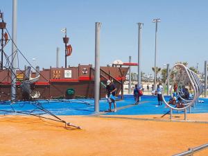 a group of people playing in a playground at Villa Miami in Ashdod