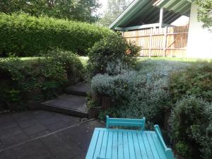 un banc bleu au milieu d'un jardin dans l'établissement Apartement Schönbach, à Holzhausen