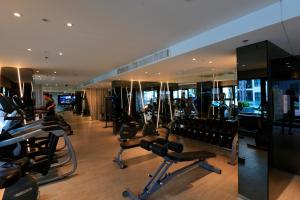 a gym with rows of exercise equipment in a building at LLX Apartments at The Base condo in Pattaya Central