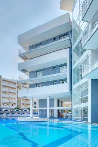 an image of a building with a swimming pool at Hotel Ambassador in Caorle