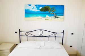 En eller flere senge i et værelse på Giardino sul mare