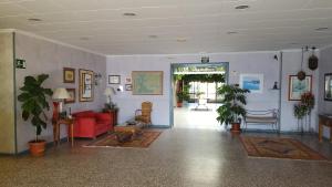 a living room with a red couch and chairs at Bahía - 30º hotels in Puerto de Mazarrón