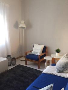 a living room with a chair and a table at Lovely and Cozy Quiaios 1 Bed Apartment in Palheiros de Quiaios