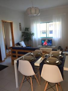 a living room with a table with dishes on it at Lovely and Cozy Quiaios 1 Bed Apartment in Palheiros de Quiaios