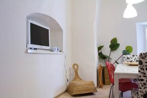 a living room with a tv on a white wall at Minihotel Graz in Graz
