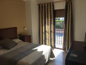 Postel nebo postele na pokoji v ubytování Hotel La Parra