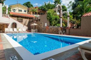 a pool at a villa with a swimming pool at Kapok Hotel in Port-of-Spain