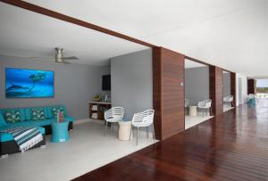 a living room with white chairs and a blue couch at Zota Beach Resort in Longboat Key