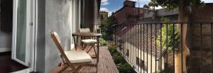 a balcony with two chairs and a table on a building at Apartment Feel Good in Zagreb