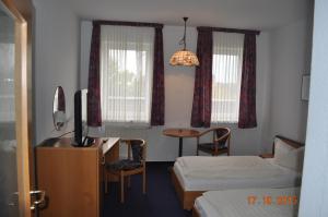 En eller flere senge i et værelse på Turmhotel Schwedt