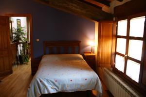 um quarto com uma cama e duas janelas em Casa Rural Ugarte Ojacastro em Ojacastro