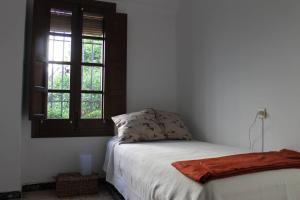Postel nebo postele na pokoji v ubytování La casita de la ciudad