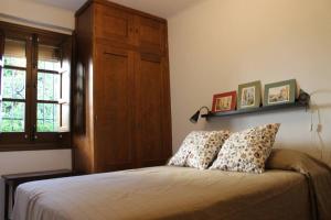 a bedroom with a bed with two pillows on it at La casita de la ciudad in Ronda