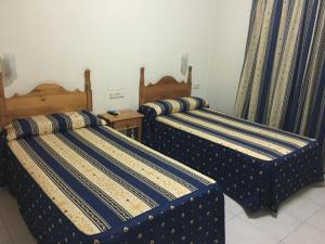 Postel nebo postele na pokoji v ubytování Hotel La Parra