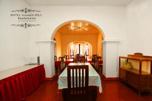 a dining room with a table and chairs at Hotel Serendib Hill in Bandarawela
