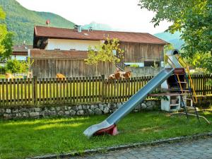 a slide in a yard in front of a fence at Biererhof in Rottau