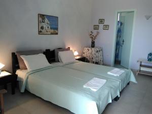 a bedroom with a large bed in a room at Daira Apartments in Diakofti