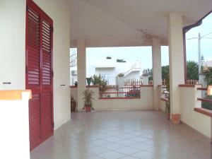 an open door to a house with a balcony at casa del sole in Sciacca