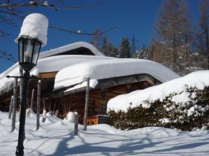 a house covered in snow with a street light at Chalet Brunnenhof in Sankt Anton am Arlberg