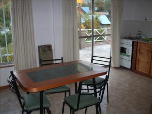 a kitchen with a table and chairs and a kitchen with a window at Estilo de Vida in Capilla del Monte