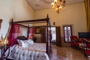 a bedroom with a large bed and a large window at Riad Damia in Fez