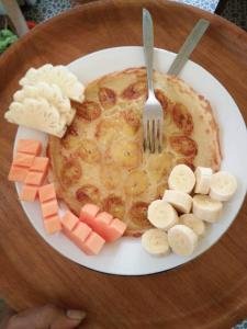 un plato de comida con tenedor y plátanos y malvaviscos en Kelapa Gading Bungalows, en Gili Air