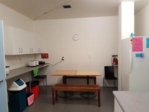 a kitchen with a table and a bench in a room at BK Hostel in Auckland