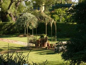 a garden with a gazebo in the grass at Ryland Estate Guest Apartment in Kaituna