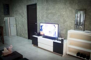a living room with a flat screen tv on a dresser at PK Villa Huahin in Hua Hin