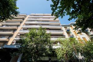 un edificio de apartamentos con árboles en el primer plano en #Luxlikehome - Art Maison, en Tesalónica