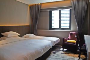 台北的住宿－兄弟大飯店，酒店客房设有两张床和窗户。