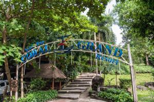 a sign in front of a house with stairs at Koh Tao Coral Grand Resort in Koh Tao