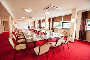 a large conference room with a long table and chairs at Hotel Diament Spodek in Katowice