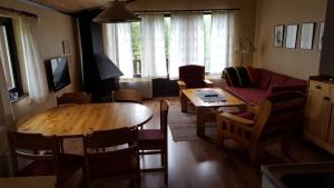 a living room with a wooden table and a couch at Sälens Bed & Breakfast Apartments in Sälen +18 photos