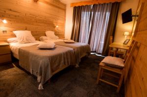 Voodi või voodid majutusasutuse Hotel Adret toas