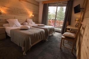 Voodi või voodid majutusasutuse Hotel Adret toas
